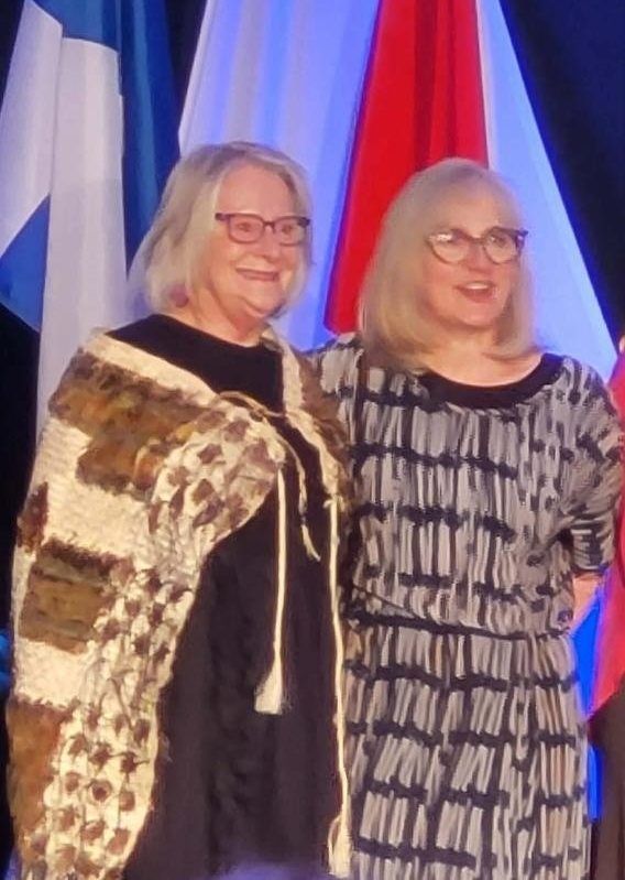 ast District Governor Jen and Governor Marie with the Kākahu